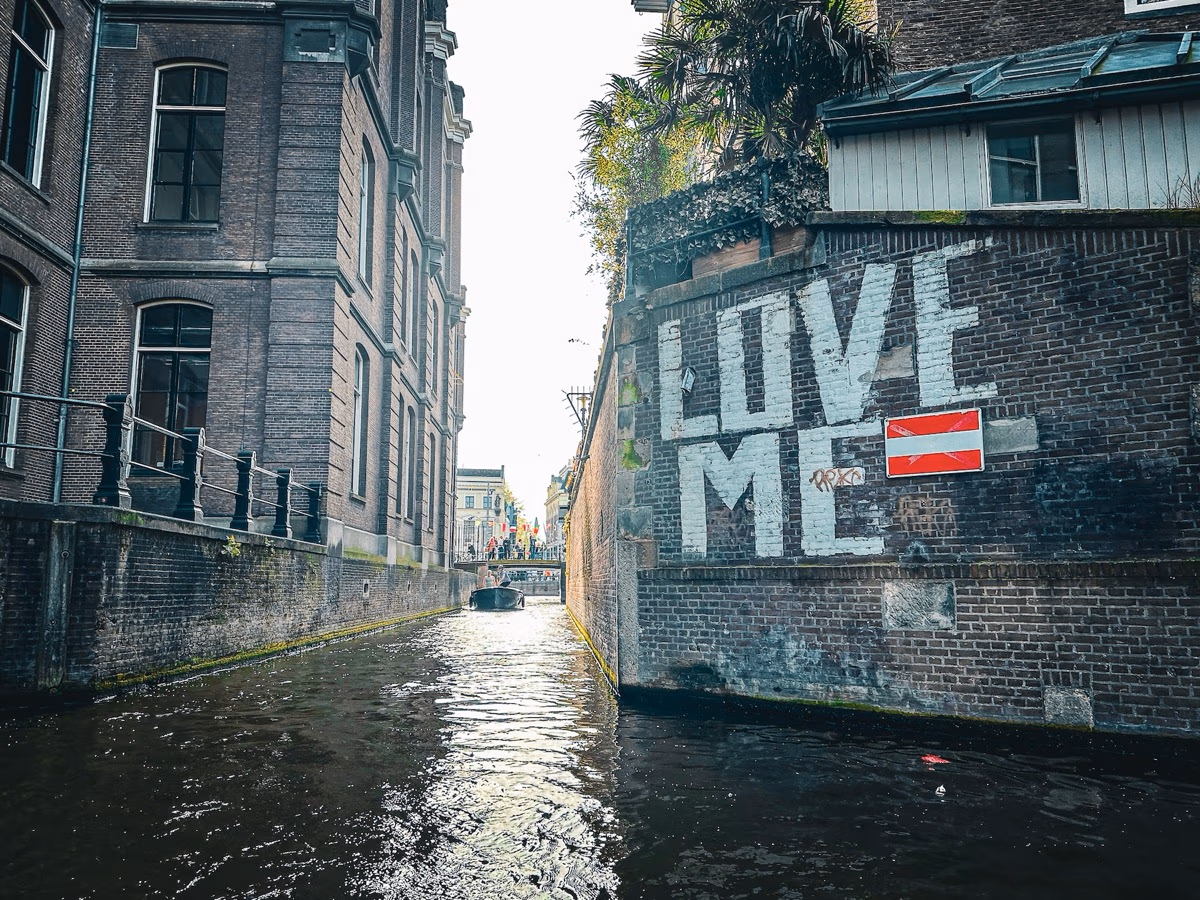 Beautiful Amsterdam canal with traditional houseboats and historic architecture