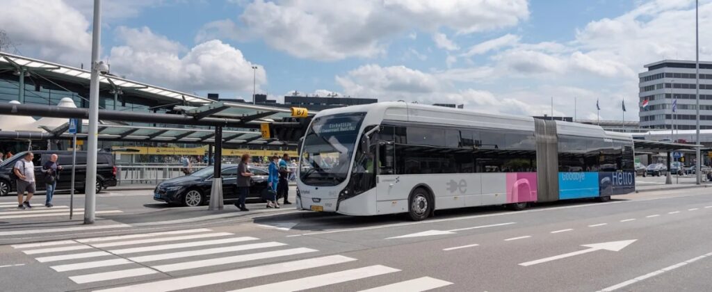 Amsterdam Airport Train vs Taxi: Which Is Better in 2026? 15 Amsterdam Airport Express bus waiting at a Schiphol bus stop