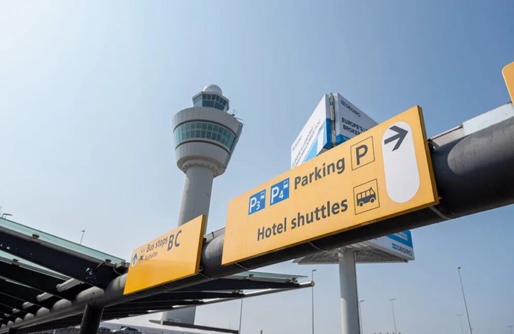 Amsterdam Airport Train vs Taxi: Which Is Better in 2026? 16 Bus parking sign outside Amsterdam Airport Schiphol