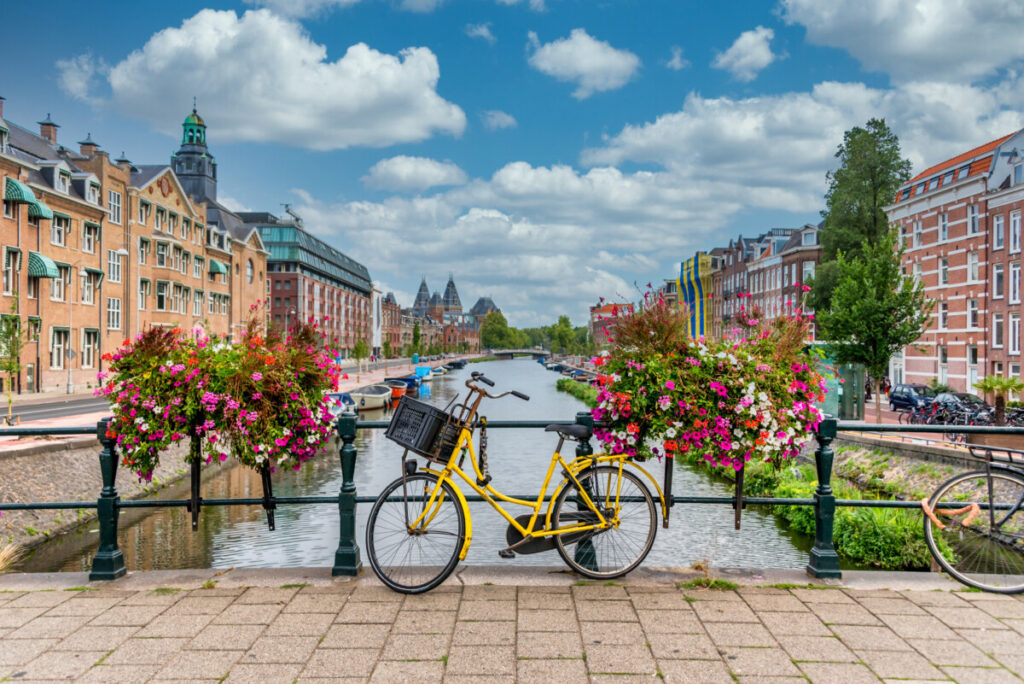 How to Get Around Amsterdam: 10 Insider Secrets for Easy City Navigation 2 Bicycle parked on a bridge spanning a canal in Amsterdam, Netherlands