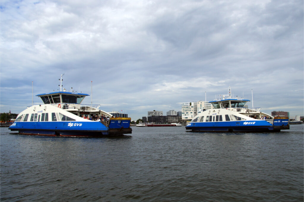 SAIL Amsterdam: 2025 Lookback and When the Next Edition Sails In (2030) 11 Two Amsterdam GVB ferries glide through the IJ harbor, showcasing the city's vibrant maritime transport