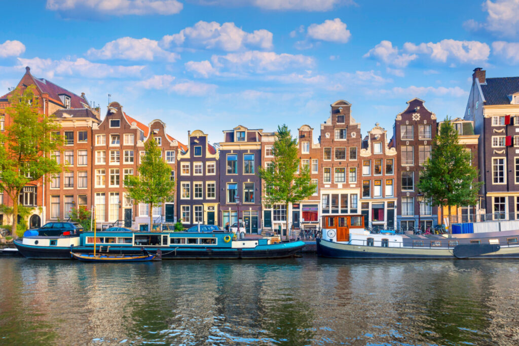 Amsterdam Airport Train vs Taxi: Which Is Better in 2026? 20 Canal houses in Amsterdam's historic city center