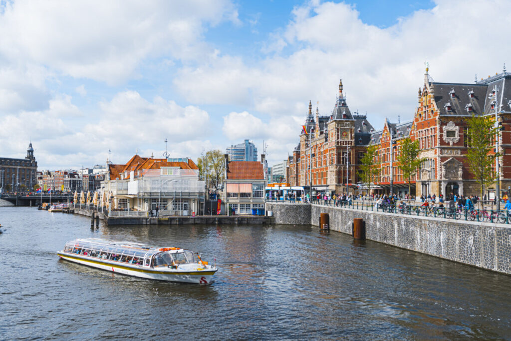 15 Iconic Amsterdam Canals: Explore the UNESCO World Heritage Waterways 19 Panoramic view of Dutch canal boat for tours and Amsterdam, Netherlands architecture