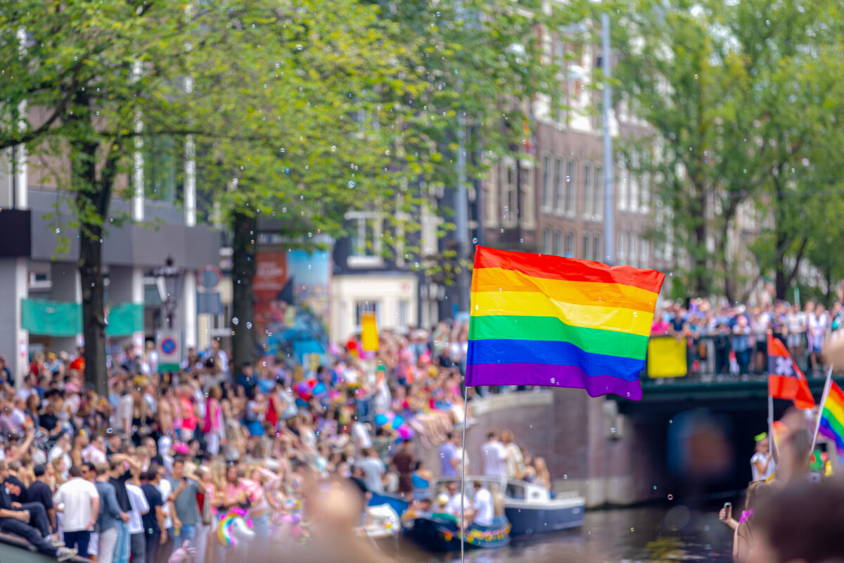Amsterdam Pride 2026: Your Guide to the Canal Parade & Saturday Party Day 1 Colorful rainbow flags decorate the canals and streets during the Amsterdam canal parade, celebrating diversity and pride.