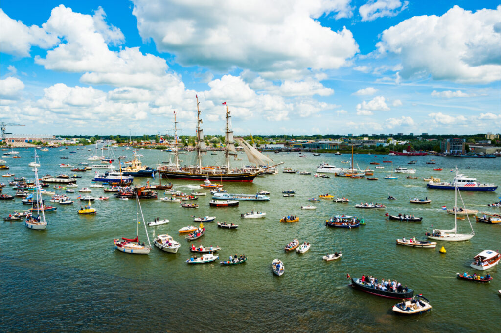 SAIL Amsterdam: 2025 Lookback and When the Next Edition Sails In (2030) 4 Tall ship is seen on a large body of water at the Amsterdam Sail event, celebrating sailing traditions and nautical activities