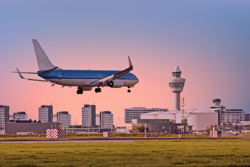 Amsterdam Airport Train vs Taxi: Which Is Better in 2026? 24 Airplane landing at Schiphol Airport in Amsterdam, Netherlands