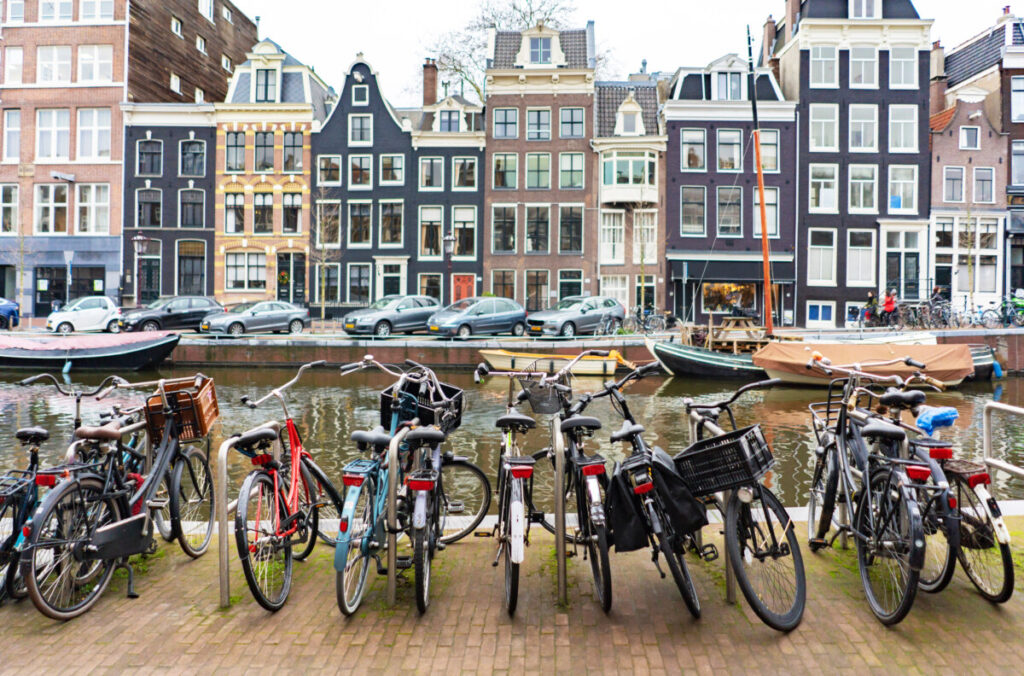 How to Get Around Amsterdam: 10 Insider Secrets for Easy City Navigation 14 Rows of parked bicycles on a street by the canal in Amsterdam, Netherlands