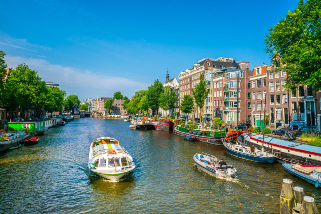 15 Iconic Amsterdam Canals: Explore the UNESCO World Heritage Waterways 14 Canal cruise and a scenic sail on a small pleasure boat through the Oudeschans Canal in Amsterdam, Netherlands