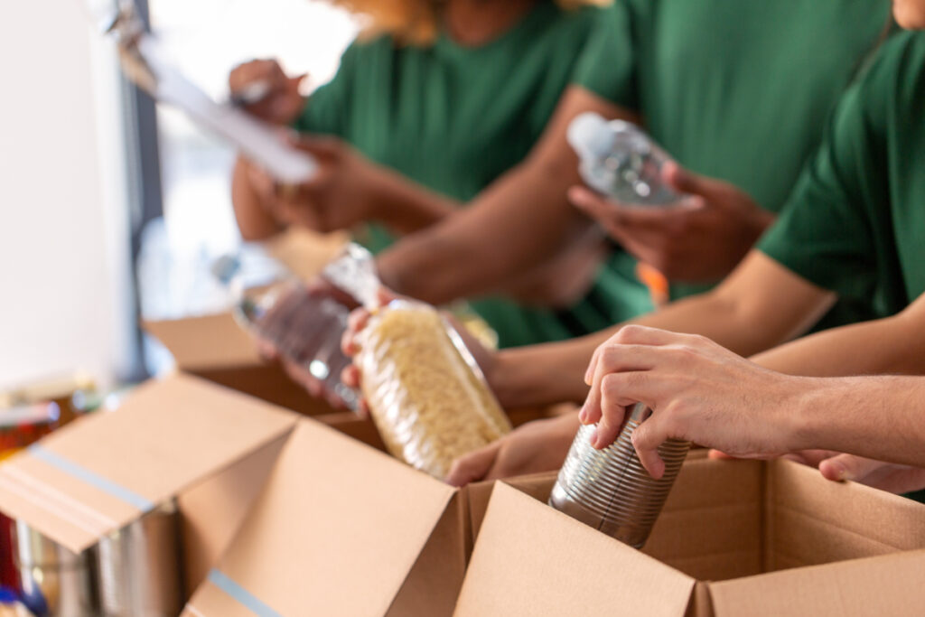 Volunteering in Amsterdam: Where to Lend a Hand 10 Charity volunteers packing food in boxes