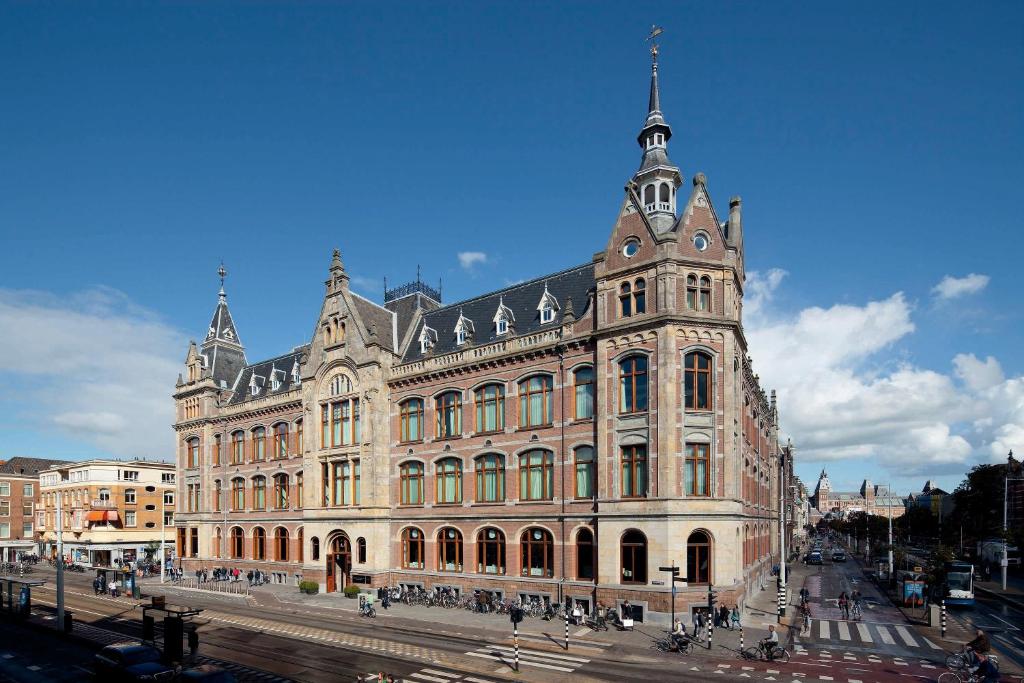 Where to Stay for Amsterdam Dance Event: 2026’s Top Areas & Insider Tips 9 The Conservatorium Hotel in Amsterdam, a large building with many windows, situated beside a bustling street.