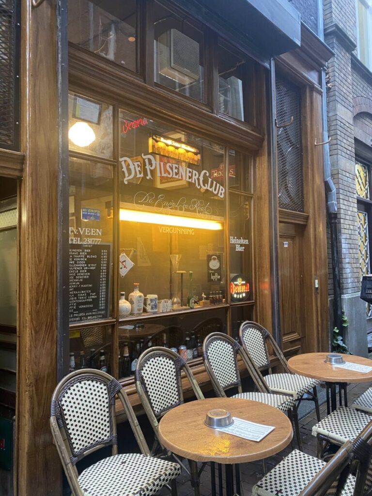 De Pilsener Club (Engelse Reet) 5 De Pilsener Club café pub entrance with vintage décor and outdoor seating.