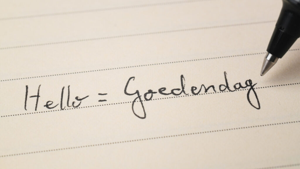 Close-up of a paper with written hello "Goedendag" in Dutch language