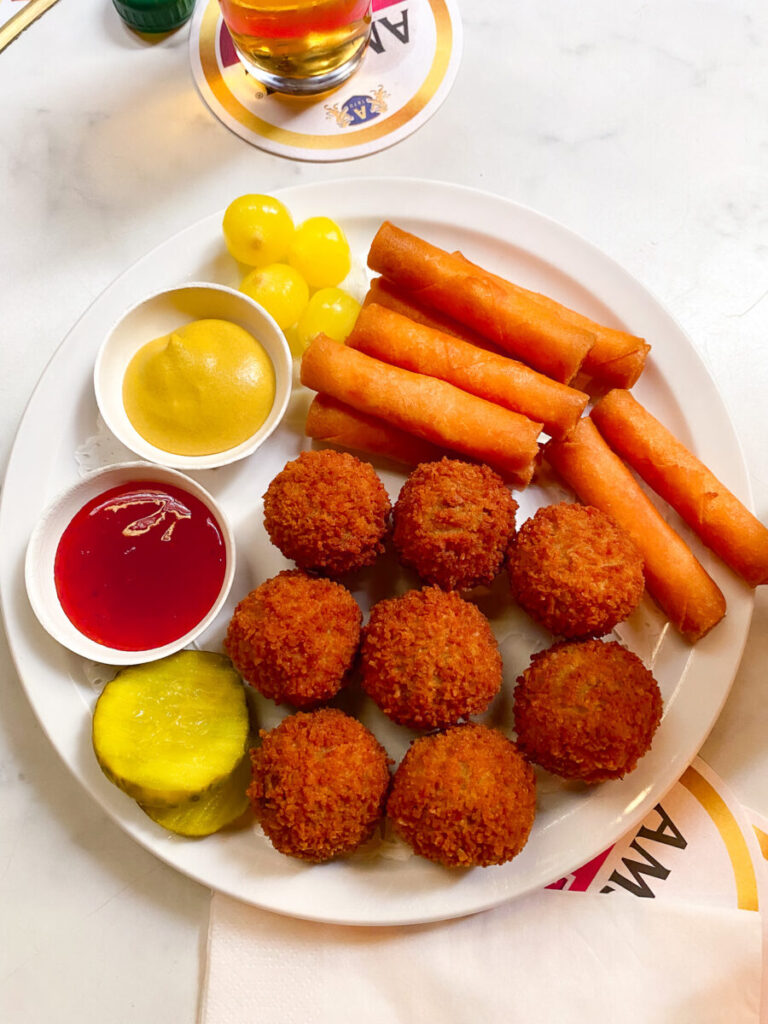 Dutch snack platter with bitterballen, cheese sticks, pickles, and mustard at Cafe Hoppe.
