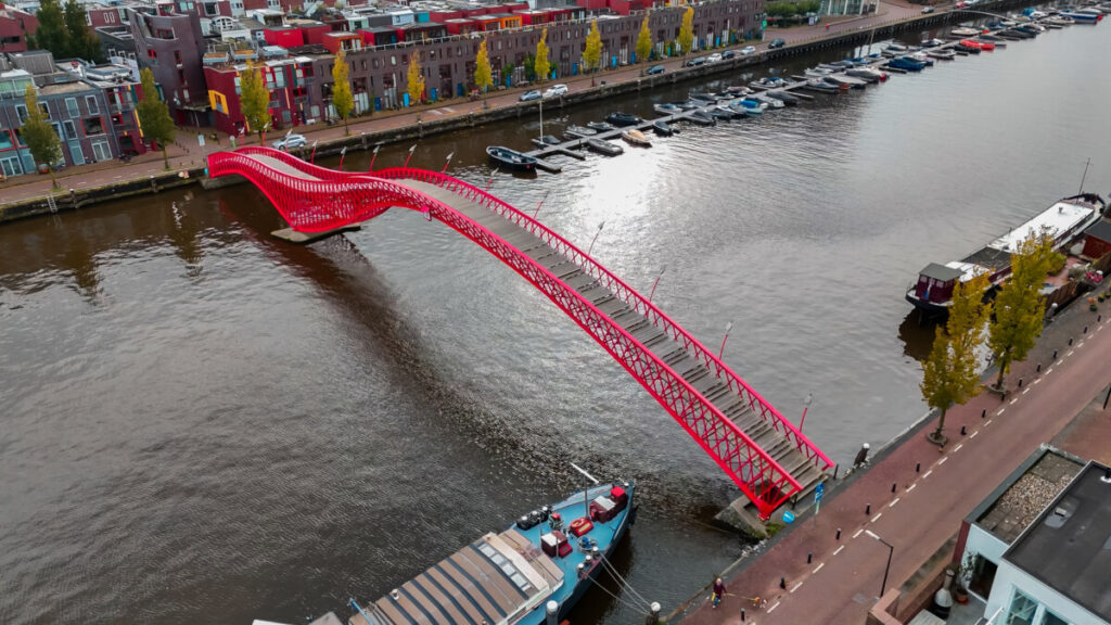 5 Essential Amsterdam Bike Rental Tips & Scenic Routes: Unlock the City Like a Local 9 Aerial view of the Python Bridge at Eastern Docklands in Amsterdam, Netherlands