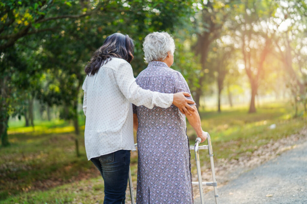 Volunteering in Amsterdam: Where to Lend a Hand 7 Woman assisting and helping an elderly woman to walk on a park