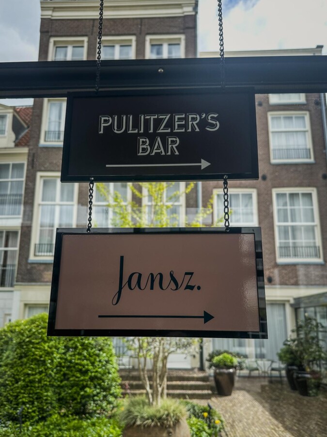 Pulitzer's Bar 5 Elegant hanging signs at Pulitzer Hotel, Amsterdam pointing to Pulitzer's Bar and Jansz Restaurant