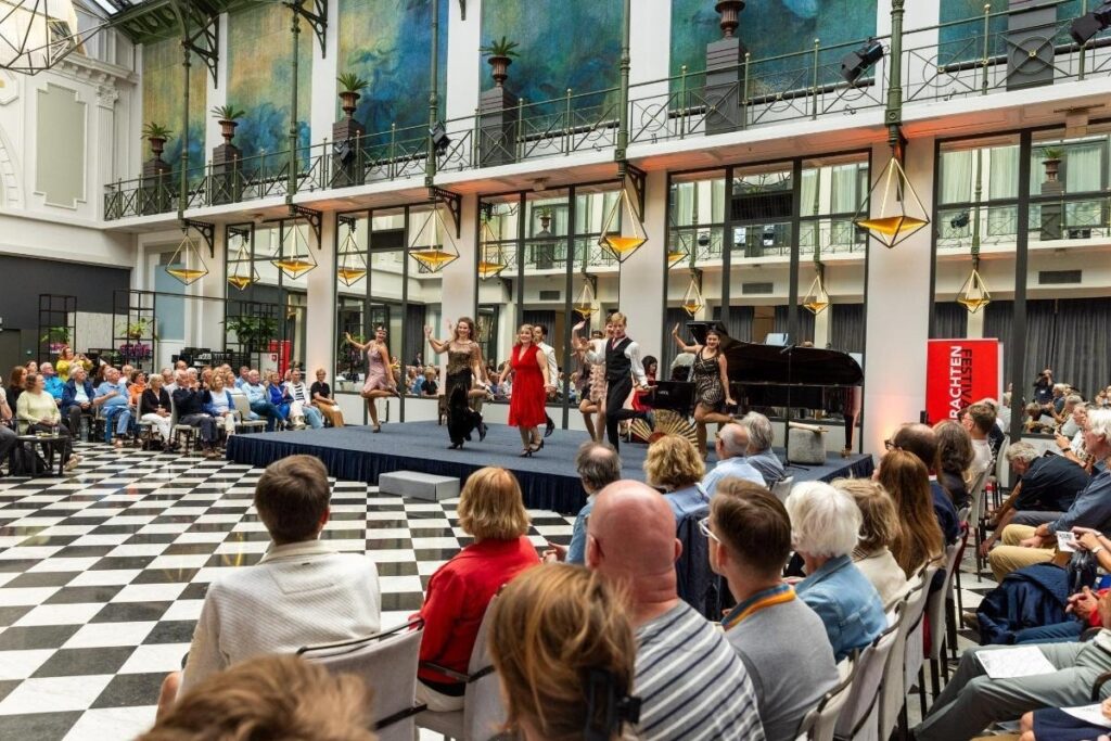Audience filling a historic Amsterdam hall for a Grachtenfestival performance