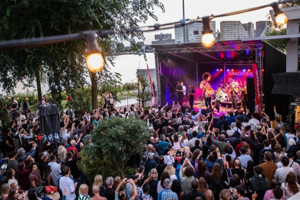 Large crowd gathered by the canal for the open-air Prinsengrachtconcert in Amsterdam