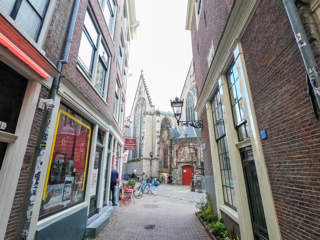 Amsterdam historic alleyway view with Oude Kerk in Red Light District