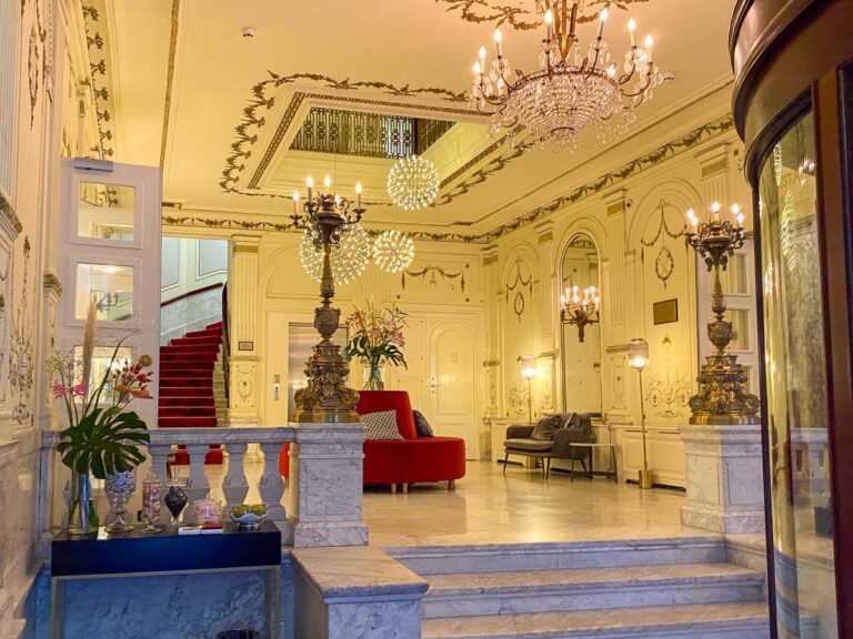 Luxurious Tivoli Doelen Amsterdam Hotel lobby with grand staircase and chandeliers