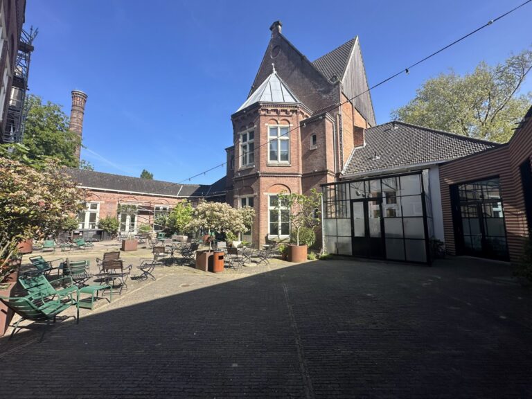 Outdoor café terrace and brick courtyard at Hotel Arena Amsterdam in Oosterpark