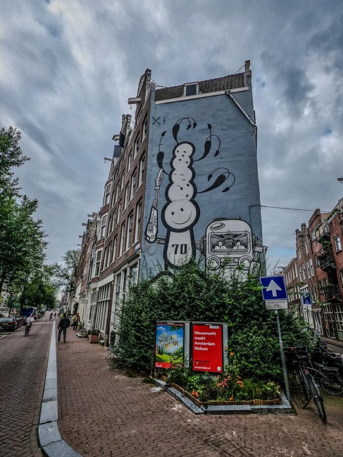 A Local’s Guide to Amsterdam’s Art Scene: Beyond the Museums 6 Jordaan Amsterdam Street Art Captivating London Police Mural With Dutch Architecture And Urban Culture