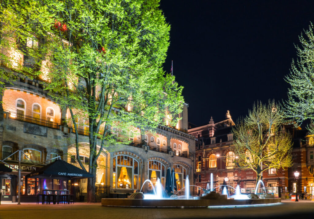 Where to Stay for Amsterdam Dance Event: 2026’s Top Areas & Insider Tips 13 Night view of Leidseplein in Amsterdam, featuring the illuminated facade of the American Hotel.