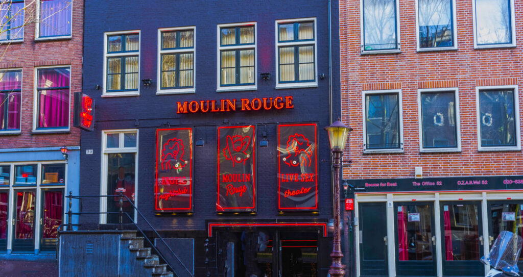 Exploring Amsterdam’s Red Light District: History, Etiquette, and Culture 6 Moulin Rouge building and other establishments at the Red Light District in Amsterdam, Netherlands