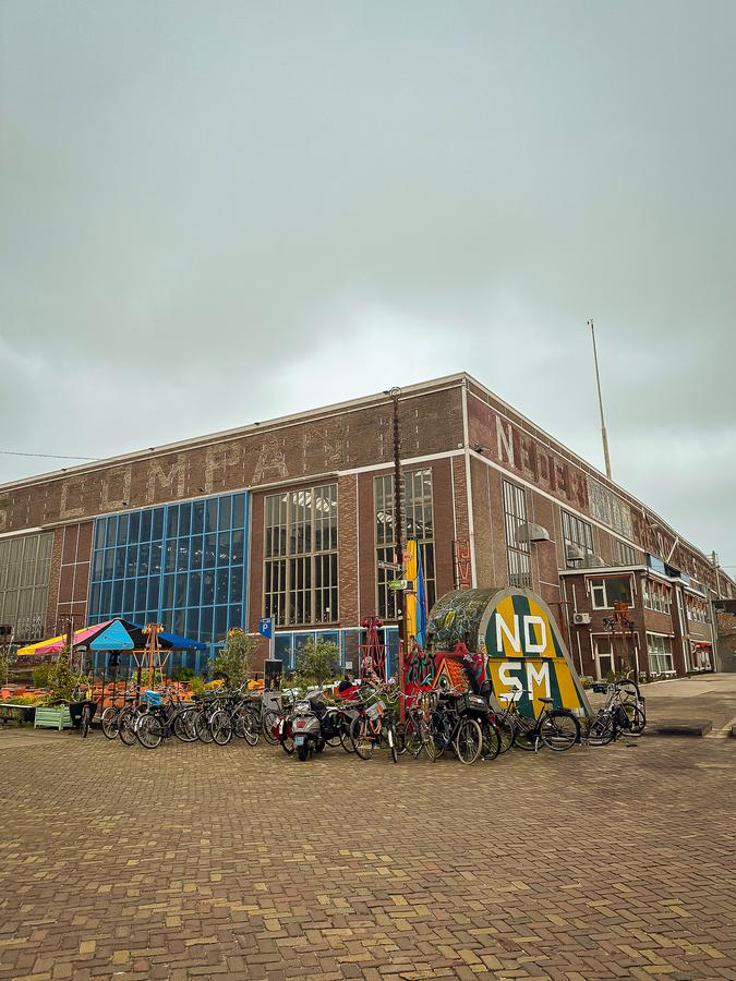 Where to Stay for Amsterdam Dance Event: 2026’s Top Areas & Insider Tips 4 NDSM Wharf Building exterior and parked bikes