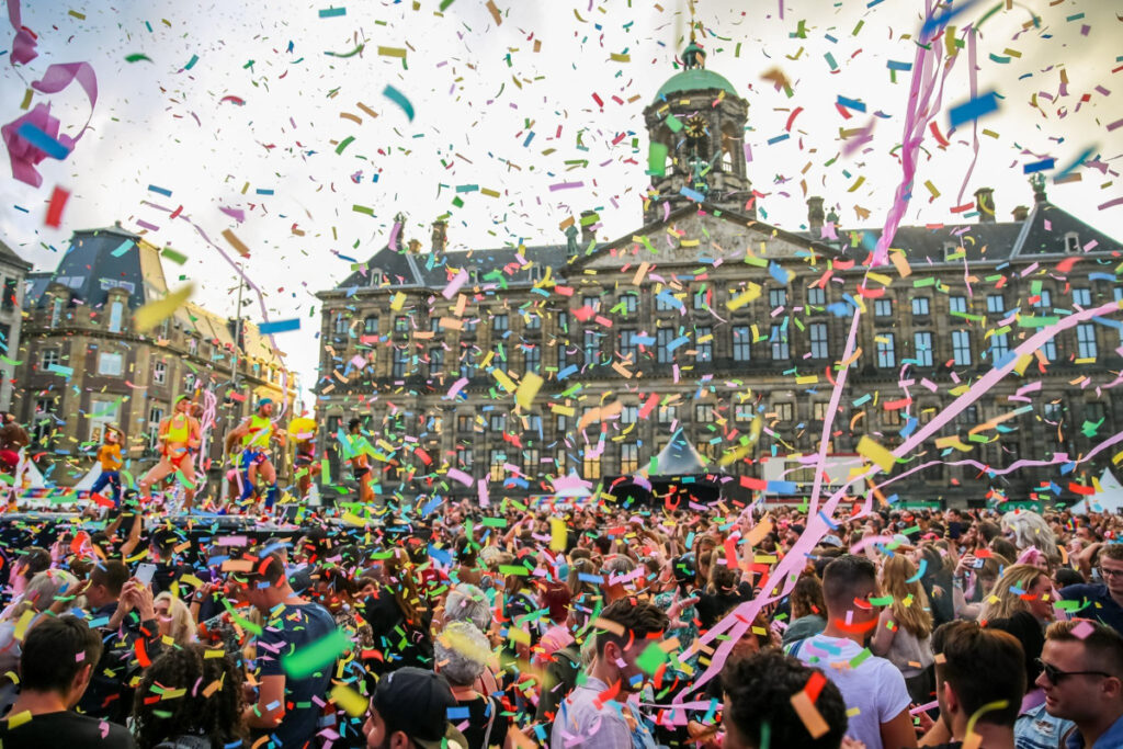 Amsterdam Pride 2026: Your Guide to the Canal Parade & Saturday Party Day 9 Enthusiastic attendees at Pride Amsterdam, joyfully celebrating amidst a shower of colorful confetti.
