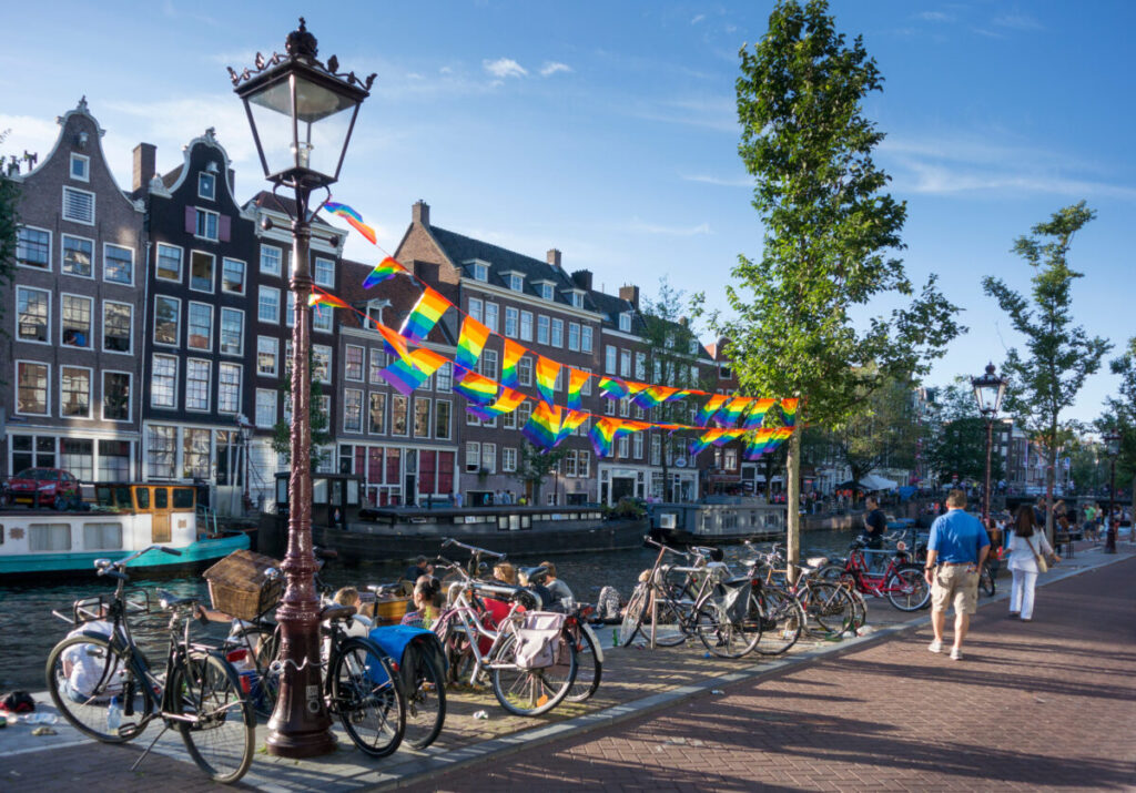Amsterdam Pride 2026: Your Guide to the Canal Parade & Saturday Party Day 6 Colorful Pride flags displayed along the canals of Amsterdam, celebrating diversity and LGBTQ+ pride.
