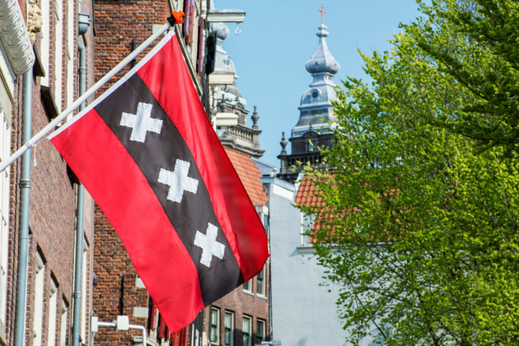 Flag of Amsterdam: 3 Striking Symbols Unveiled 8 Flag of Amsterdam raised and displayed at a building in the center of the city