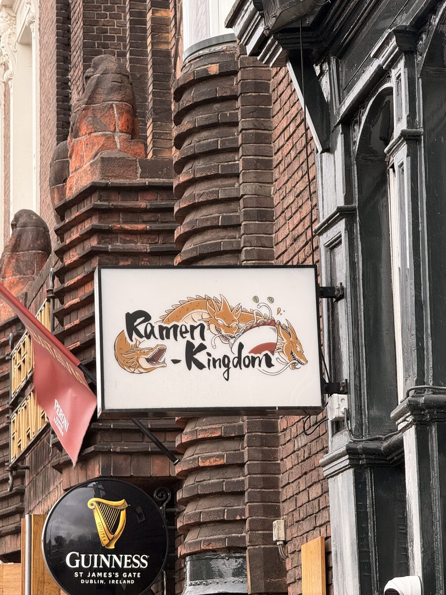 Ramen Kingdom 4 Ramen Kingdom hanging storefront sign on a historic brick facade near Amsterdam Centraal