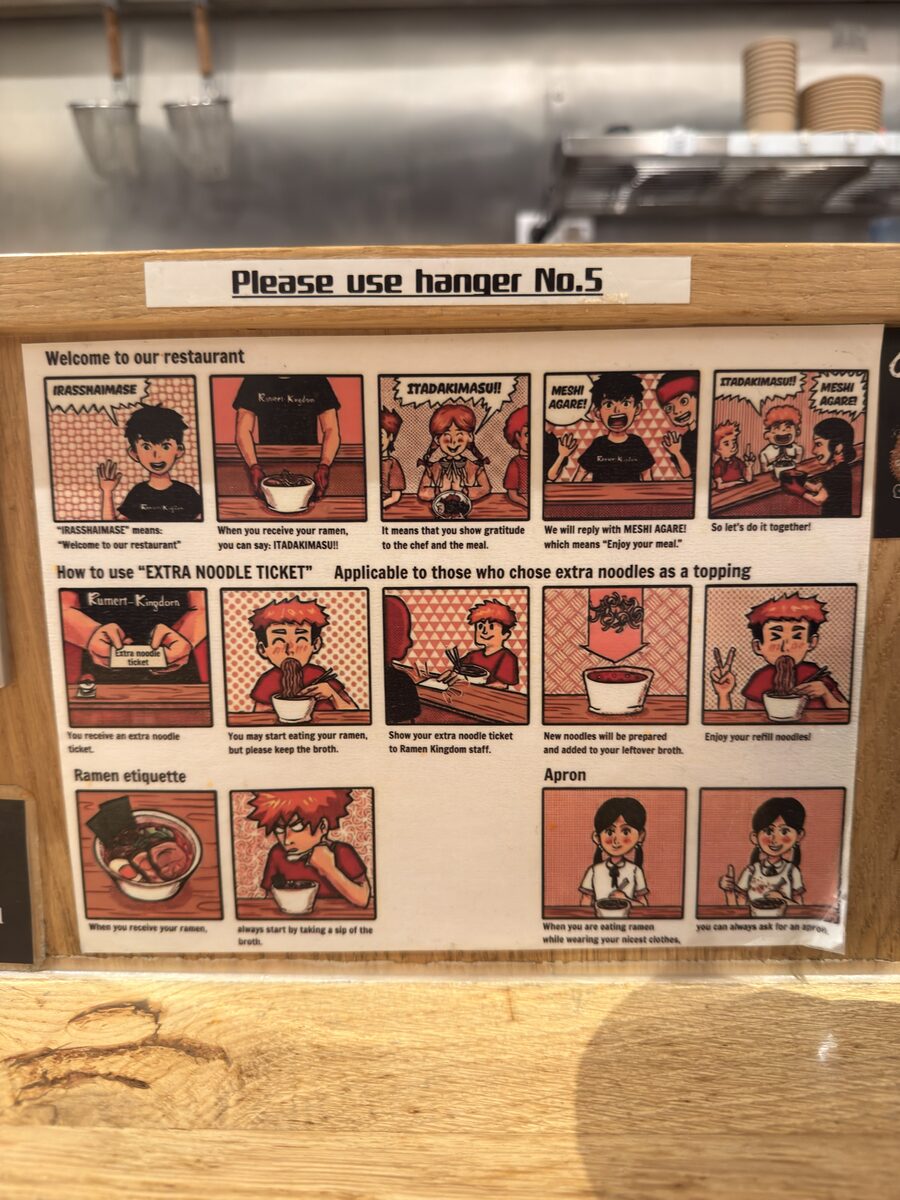 Ramen Kingdom 6 Illustrated manga board explaining counter etiquette and extra noodle refill tickets