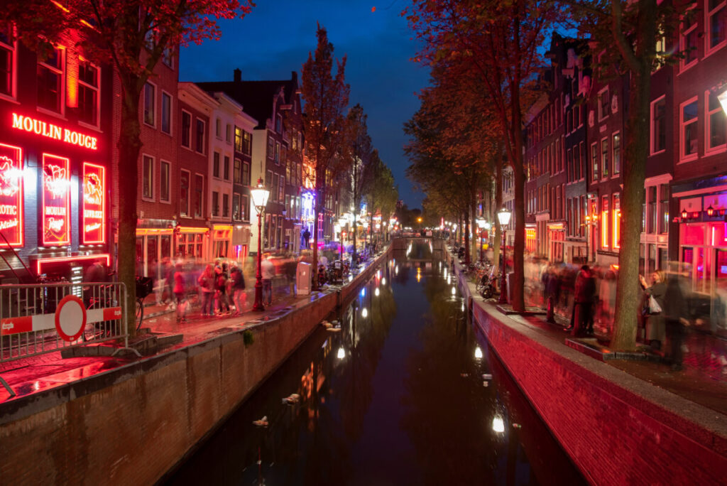 Exploring Amsterdam’s Red Light District: History, Etiquette, and Culture 4 Canal and the night lights at the Red Light District in Amsterdam, Netherlands