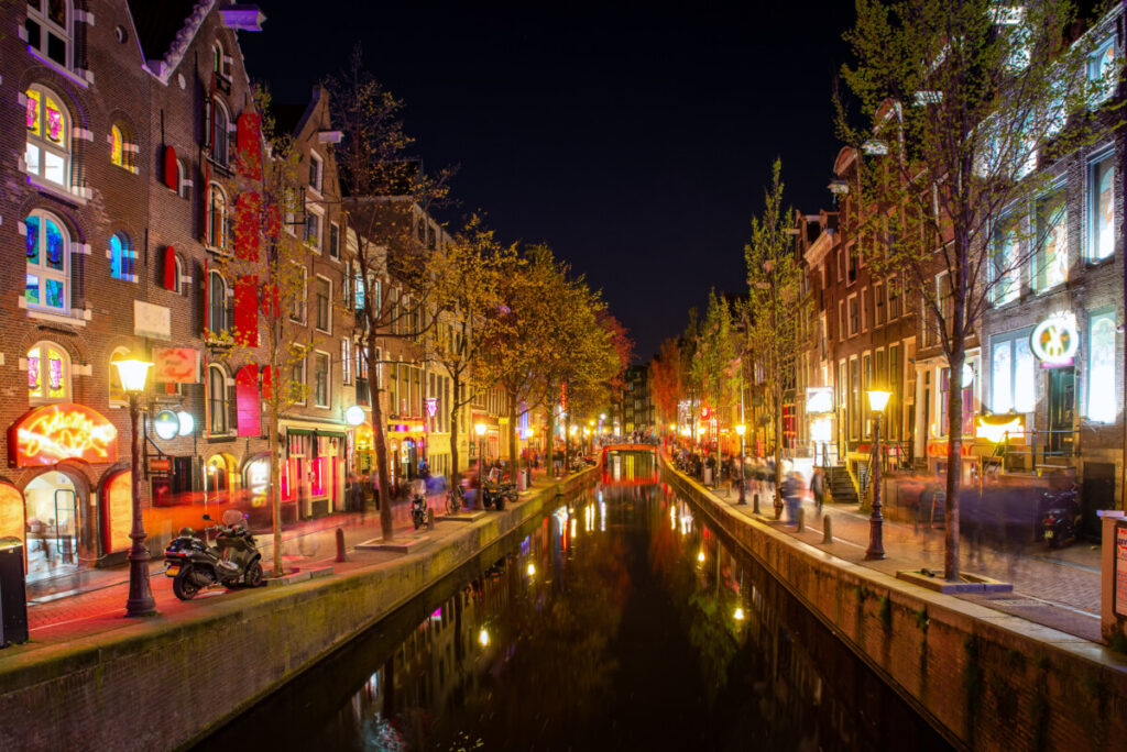 Exploring Amsterdam’s Red Light District: History, Etiquette, and Culture 10 Canal, night lights, and establishments at the Red Light District in Amsterdam, Netherlands