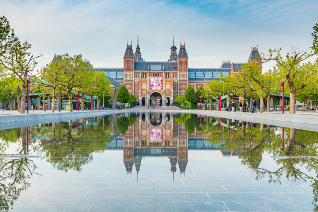 Amsterdam Airport Train vs Taxi: Which Is Better in 2026? 21 Rijksmuseum facade beside Museumplein in Amsterdam