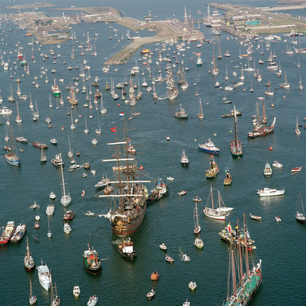 SAIL Amsterdam: 2025 Lookback and When the Next Edition Sails In (2030) 7 Aerial view of numerous boats gathered in the water during the SAIL Amsterdam event, showcasing vibrant maritime activity.