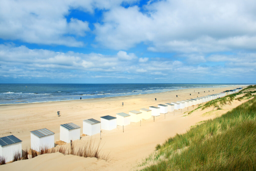 Walking the Netherlands' New Long-Distance Salt Path: A Journey Through Nature and Culture 28 Row of beach huts and the coast of Waden Sea at Texel, Netherlands