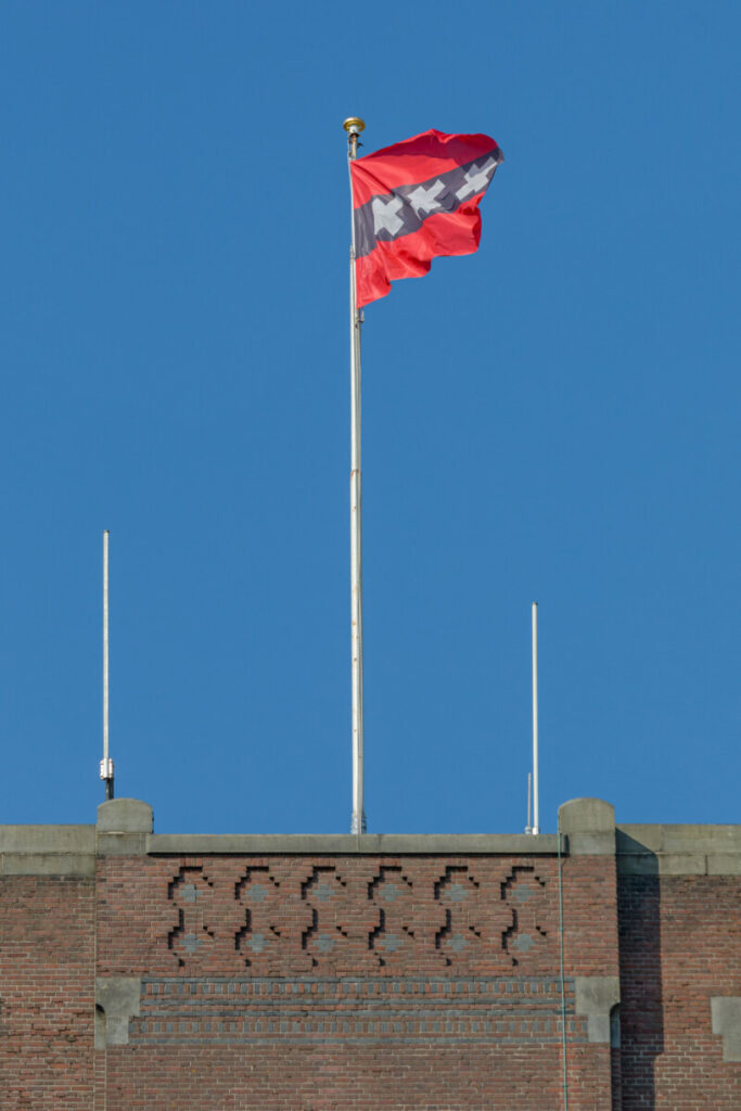 Flag of Amsterdam: 3 Striking Symbols Unveiled 5 Flag of Amsterdam flying on a pole atop a building