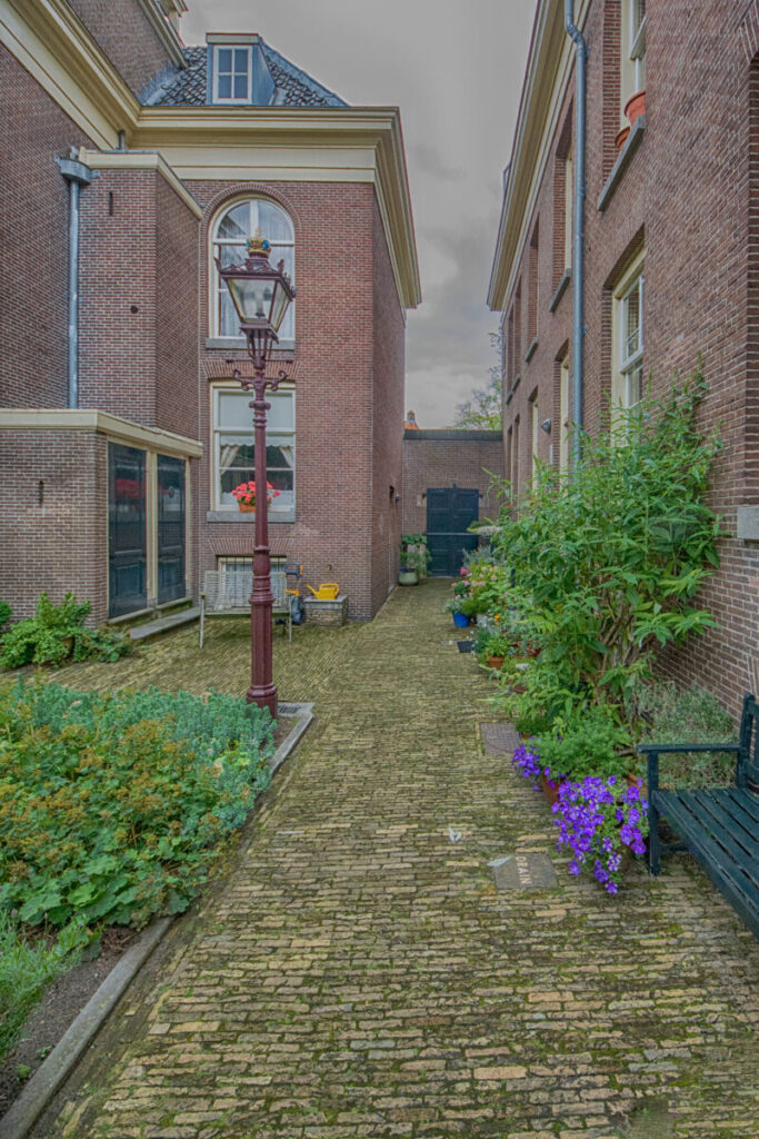 How to Find Hidden Hofjes in the Jordaan: Secret Courtyards & Local Tips 4 Van Brienen Hofje in Amsterdam, featuring traditional Dutch architecture and a serene courtyard with greenery.