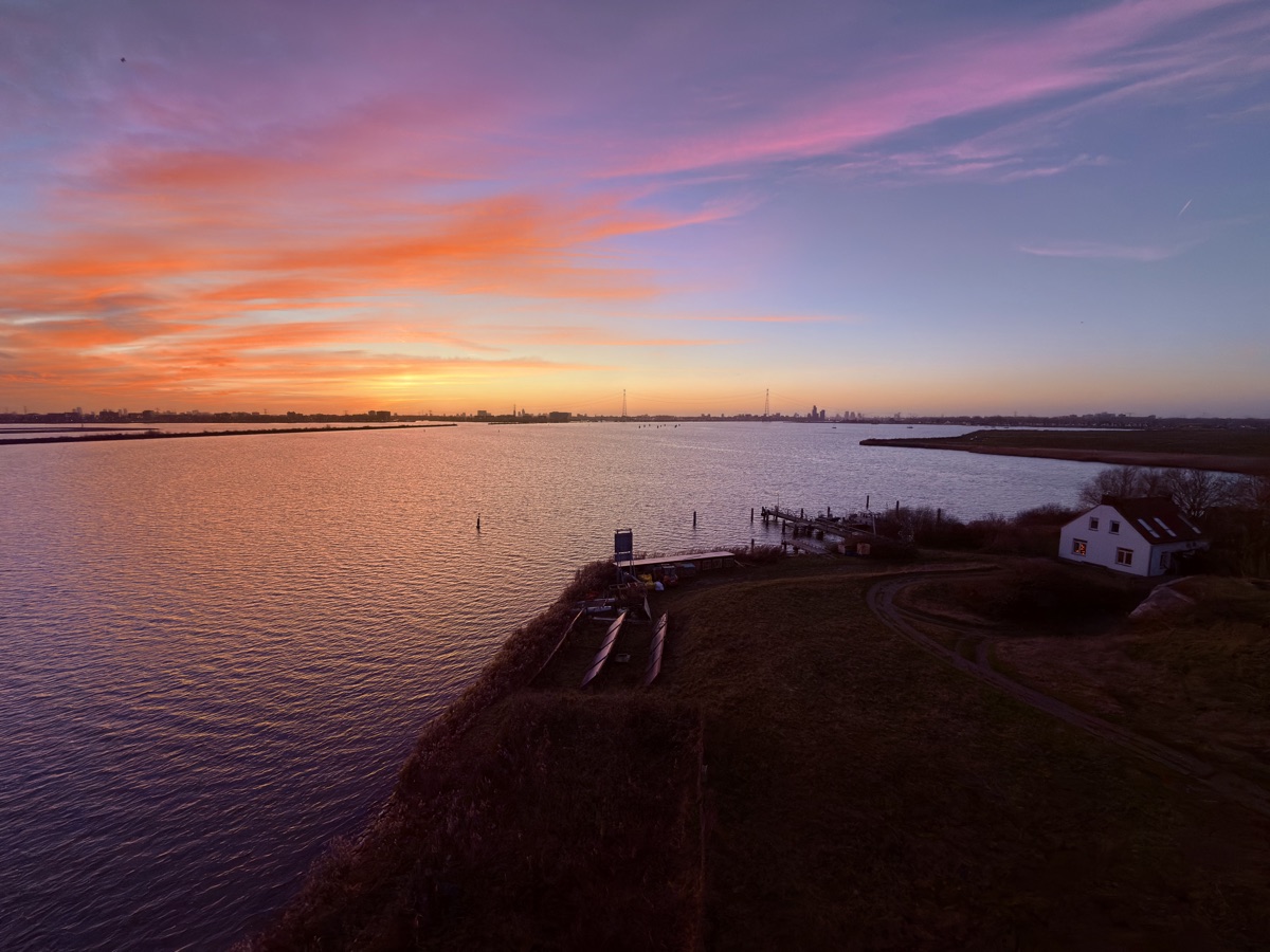 Vuurtoreneiland 14 Aerial sunset panorama from the lighthouse overlooking the harbor, keeper house, and the IJmeer towards Amsterdam