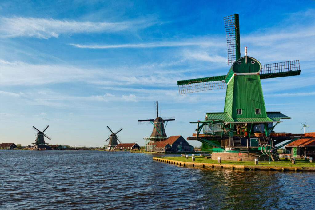 Kinderdijk vs Zaanse Schans Windmills: Which Dutch Icon Wins? 17 Close-up of windmills at Zaanse Schans in Holland during sunset, showcasing vibrant colors and serene atmosphere.